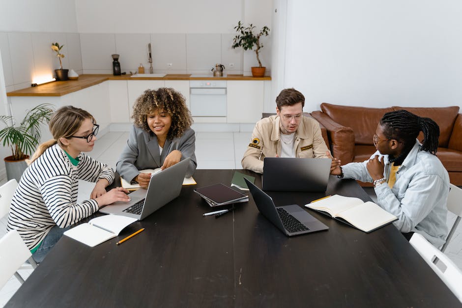 A group of diverse people working together on laptops